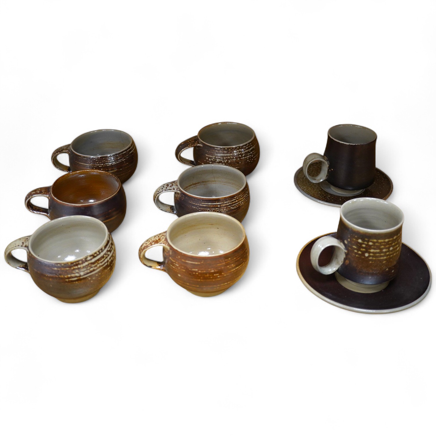 Guy Sydenham (1916-2005), two studio pottery cups and saucers, together with six teacups, incised marks, largest 13.5cm in diameter